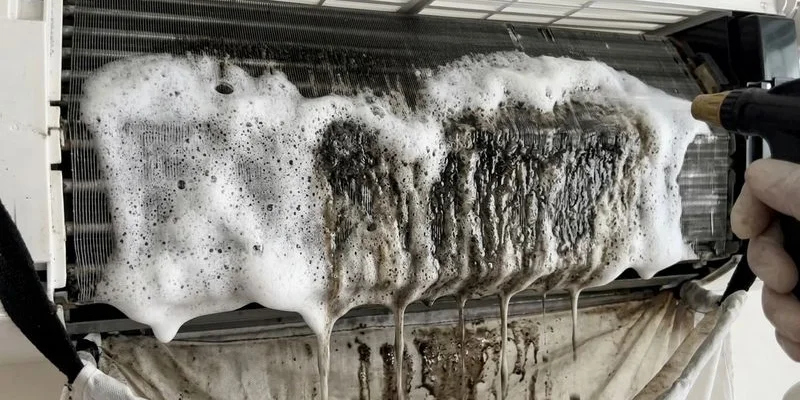 Chemical solution being applied to dirty evaporator coils