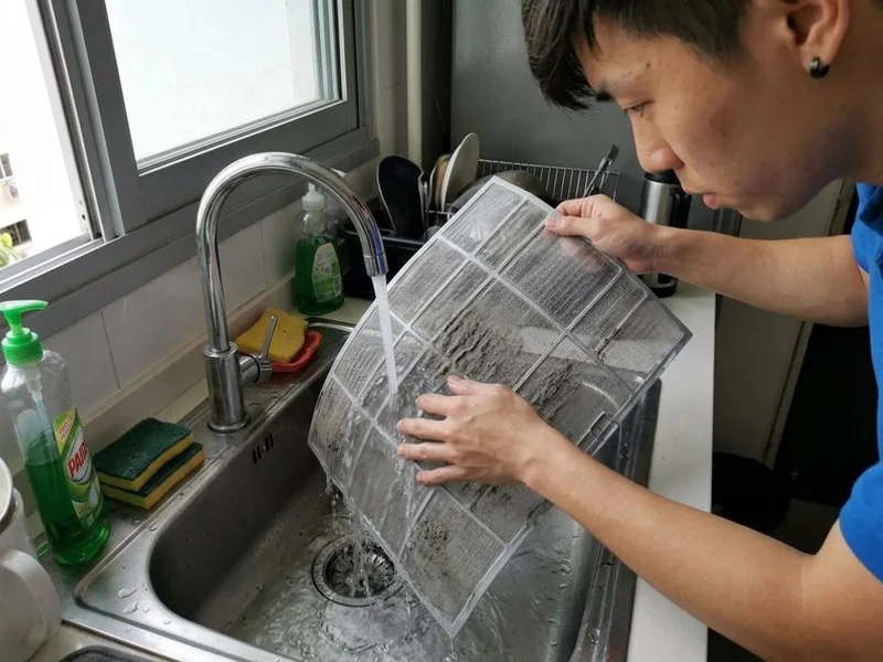 Close-up of aircon filter being cleaned during regular maintenance service