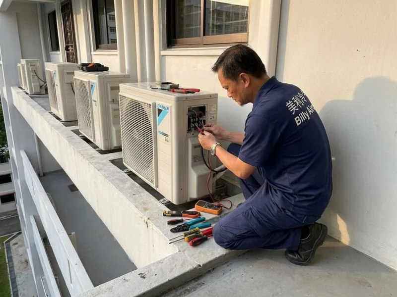 Billy Aircon technician servicing a Daikin outdoor compressor unit at a Singapore HDB corridor