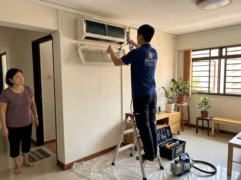 Billy Aircon technician servicing an aircon unit in Woodlands, Singapore