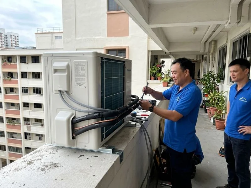 Outdoor condenser unit securely installed on an HDB aircon ledge with proper bracket mounting