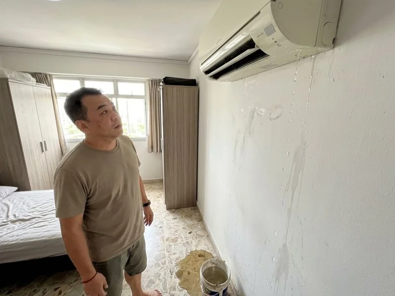 Water dripping from an indoor aircon unit onto the floor below in a Singapore home